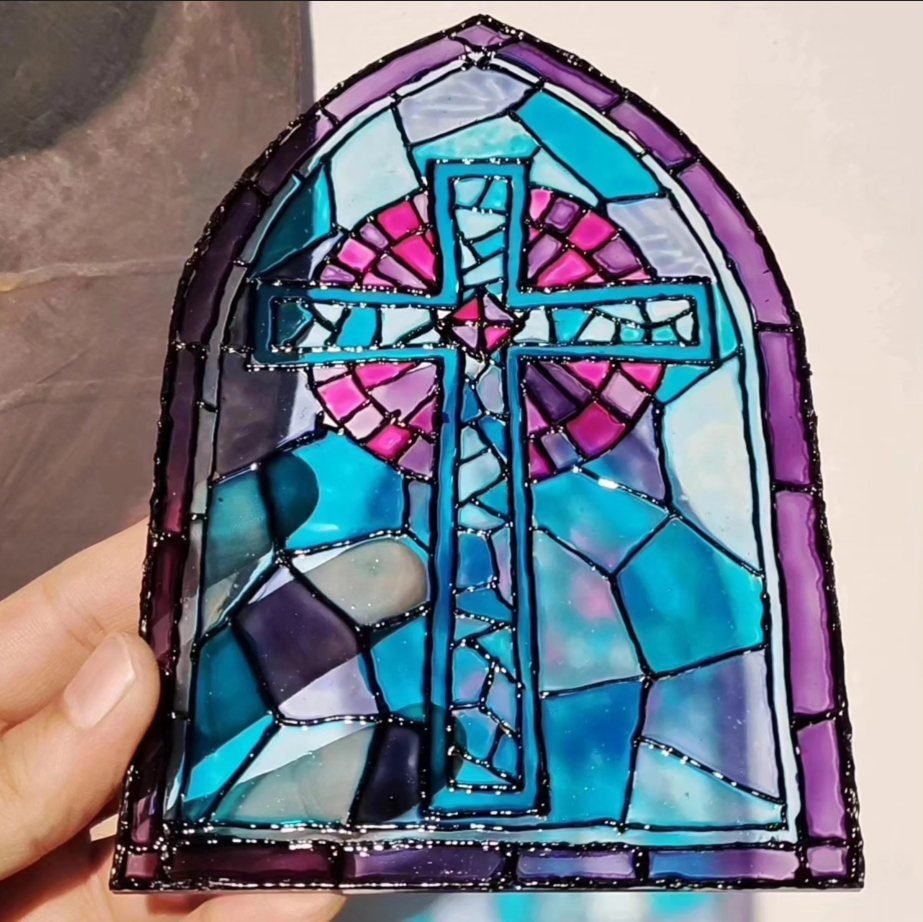Glass painting of a cross in blue and purple made in a glass painting workshop in Amman