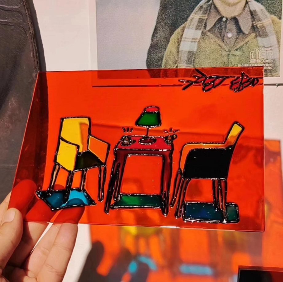 Glass painting of a room with table and chairs on orange glass, made at Gilgamesh for Creative Arts, Amman