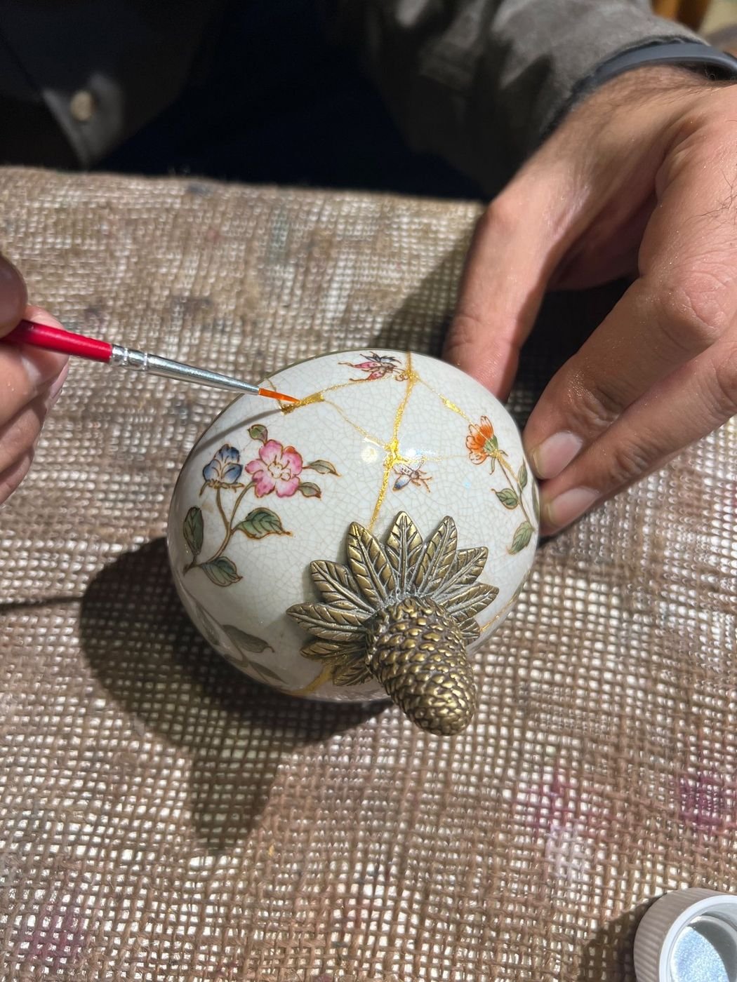 Kintsugi Repair & Restoration in Jordan 6 Kintsugi repair in progress on a floral porcelain pot at Gilgamesh for Creative Arts, Amman