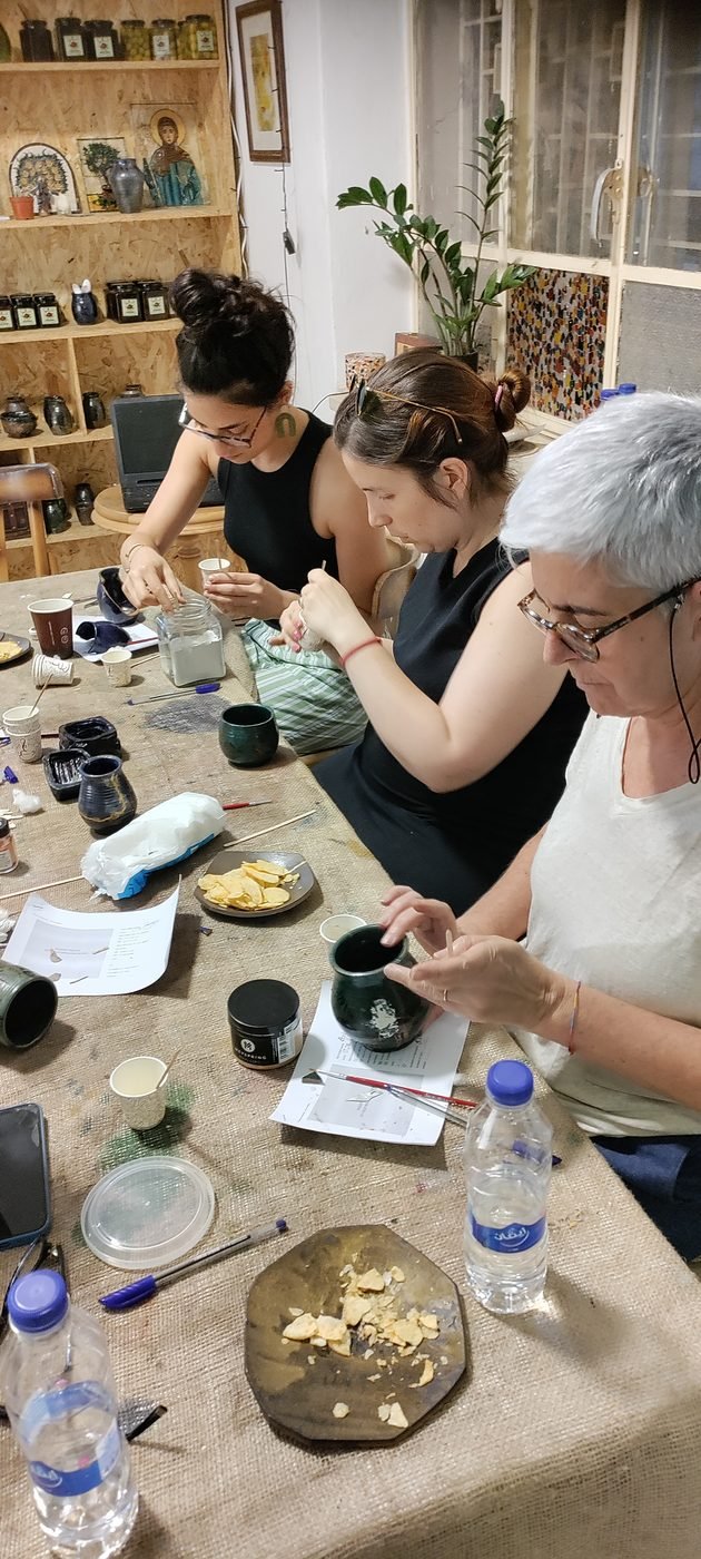 Participants working on Kintsugi repairs during a workshop at Gilgamesh, Amman