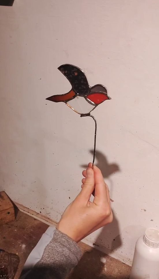 Finished stained glass bird hanging in the light at Gilgamesh for Creative Arts, Jabal Al-Lweibdeh