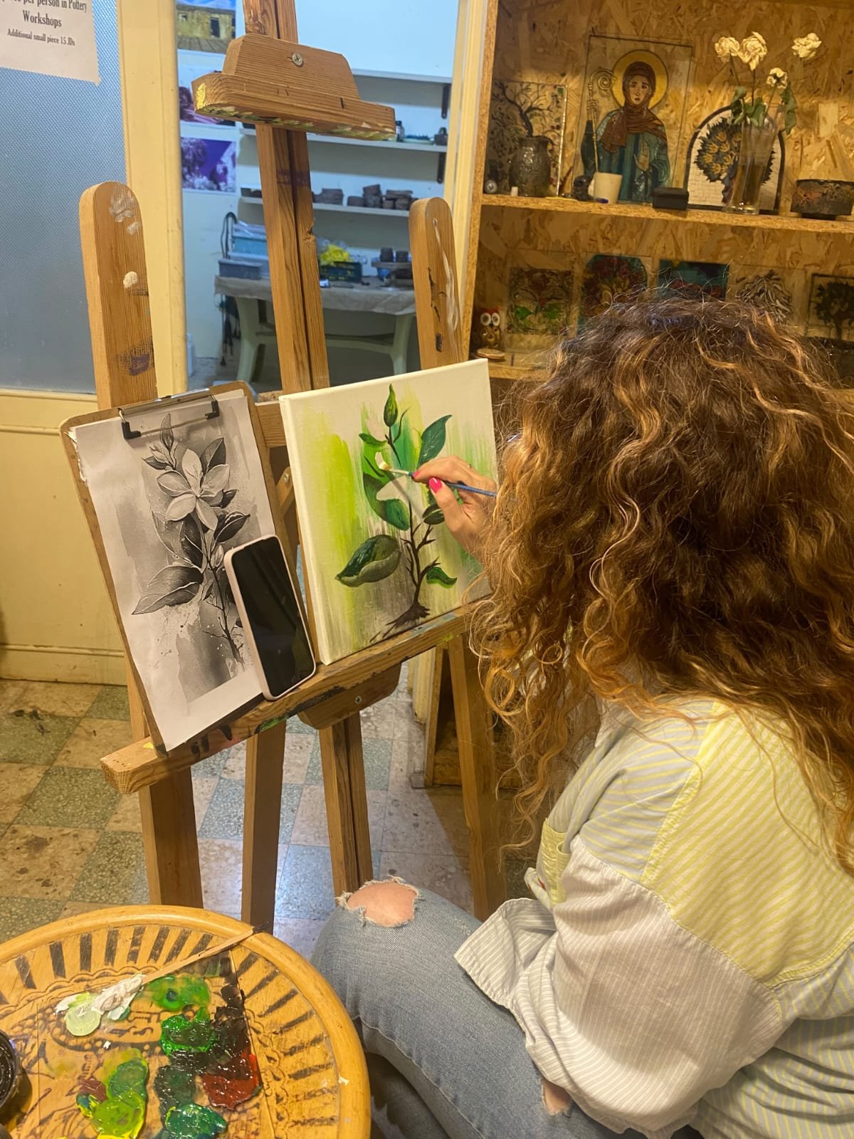 Couples Workshops & Date Night in Amman 3 A guest painting green leaves on a canvas with acrylics at Gilgamesh, Amman