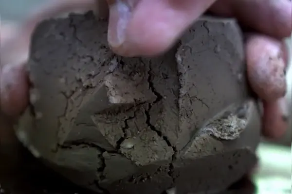 Hands carving a block of clay in a Kurinuki masterclass at Gilgamesh